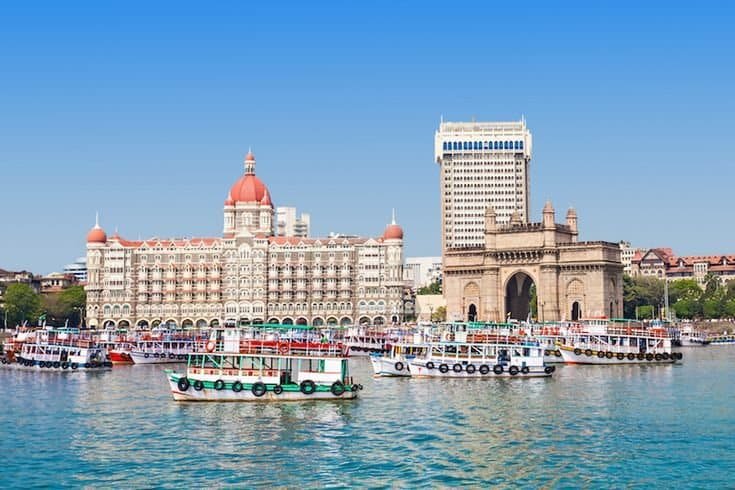 Luxury panoramic view of South Goa pristine coastline at golden sunset with swaying coconut palms during the luxury Mumbai Goa tour
