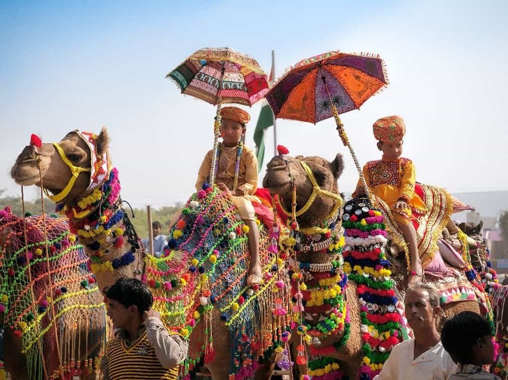 Pushkar Camel Fair in Rajasthan with camels and traditional costumes
